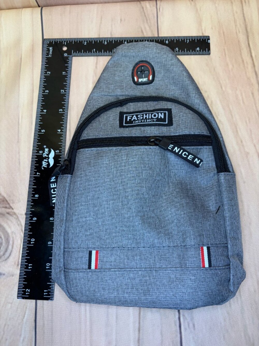 Gray sling backpack designed for convenient, hands-free everyday carrying